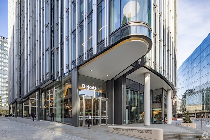 Curved glazed entrance and Deloitte signage at the London offices