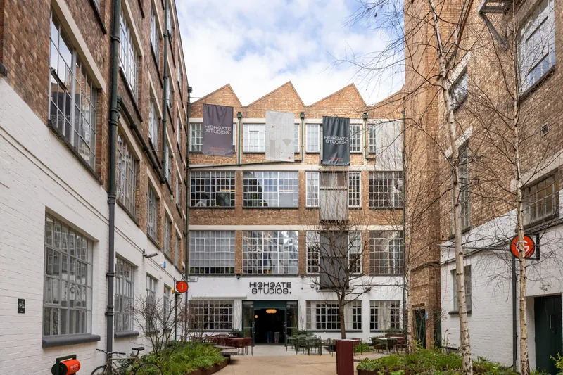 Brick courtyard entrance and sawtooth roofline at Highgate Studios